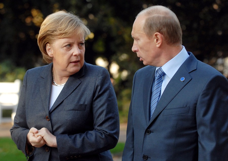 Russia's President Putin talks to German Chancellor Merkel at the Kurhaus resort garden in Wiesbaden