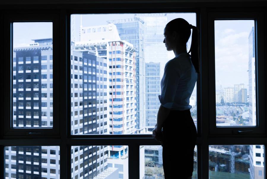Woman in he office looking out the window.