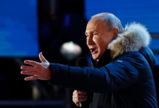 Russian President and Presidential candidate Putin delivers a speech during a rally and concert marking the fourth anniversary of Russia's annexation of the Crimea region, in Moscow