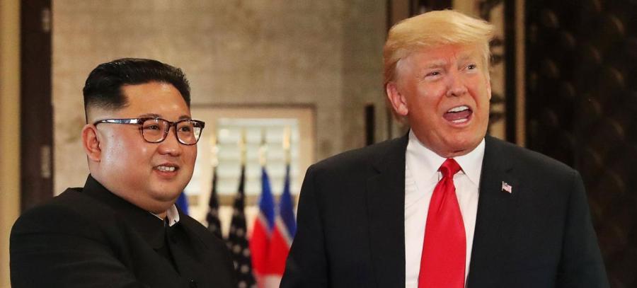 U.S. President Donald Trump and North Korea's leader Kim Jong Un shake hands after signing documents during a summit at the Capella Hotel on the resort island of Sentosa, Singapore
