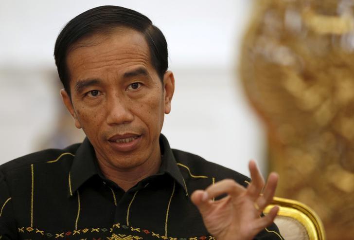 Indonesian President Joko Widodo gestures while speaking with Reuters during an interview at the presidential palace in Jakarta, Indonesia
