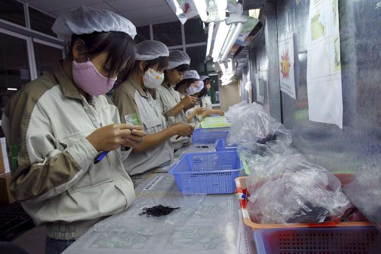 ASEAN Women working at a plastic factory, which makes plastic parts for electronic production, in Que Vo district, outside Hanoi. PHOTO REUTERS415