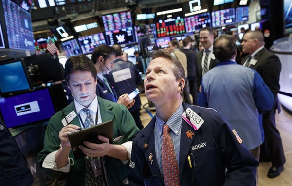 Traders work on the floor of the New York Stock Exchange - part of the complex system of global financial markets. Justin Lane EPA file-20200206-59236-gt08
