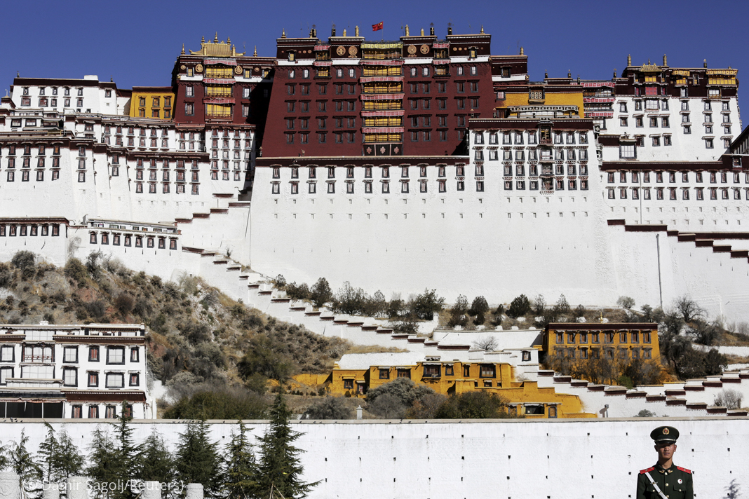 A paramilitary policeman stands guard in front of the Potala Palace in Lhasa, Tibet Autonomous Region